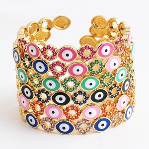 Detailed close-up of wide open cuff bracelet with colorful enamel evil eye patterns
