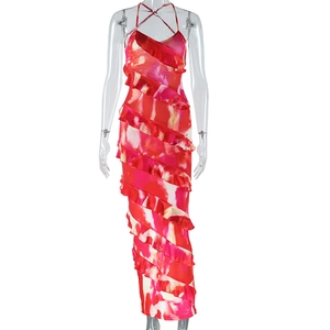 Detail of red floral halter dress featuring criss-cross back straps and ruffled hemline