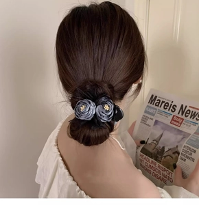 Detail of fabric flower hair claw clip in grey blue lace for elegant bun hairstyles