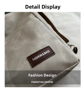 Macro shot of stylish faux leather patch with embossed logo on beige canvas tote bag