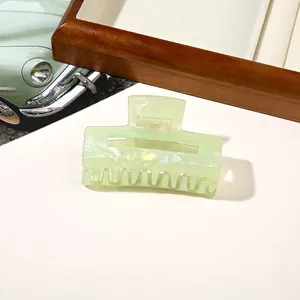 Close-up of light green pearlescent hair claw clip with a hollow square design