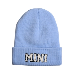 Close-up of light blue beanie with white MINI letter embroidery and knit texture