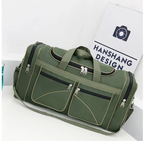 Detail of army green travel bag showing multiple zipper pockets and durable oxford fabric