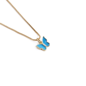 Elegant gold butterfly necklace with blue enamel and rhinestone on white background