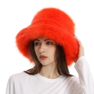 Vibrant orange faux fur bucket hat for women with a warm plush texture for winter