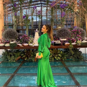 Elegant emerald green satin maxi dress with long sleeves and pleated fishtail hem