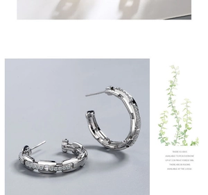 Detailed view of silver geometric chain hoop earrings with micro-pave cubic zirconia