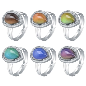 Detailed view of adjustable silver rings with teardrop-shaped color-changing gemstones