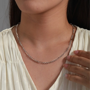 Minimalist silver chain necklace with geometric links on model in soft lighting