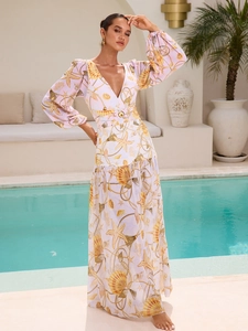 Detail of starfish and seashell print on long-sleeved swimwear with gold ring waist belt