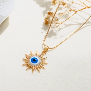 Detail der Sonnenkette mit blauem Evil-Eye-Anhänger und weißen Strasssteinen