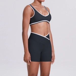 Detail of high-waist crisscross shorts and V-neck sports bra with white piping detail