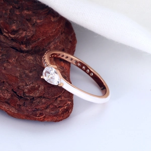 Detail of rose gold S925 silver ring featuring pear-cut zircon and white enamel finish