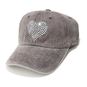 Close-up of heart-shaped rhinestone pattern on dark grey washed cotton baseball cap