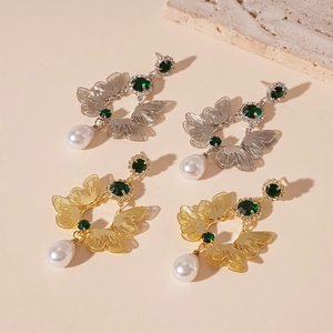Vintage gold butterfly drop earrings with green stones and elegant white teardrop pearls