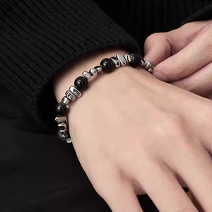Minimalist black gallstone beaded bracelet with stainless steel splice on wrist