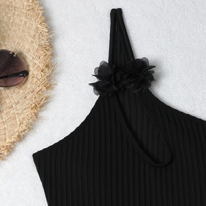 Detail of black ribbed swimsuit top featuring elegant 3D mesh floral shoulder embellishments