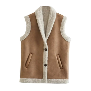Detail of brown faux suede vest with warm white faux shearling lining and button closure