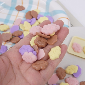 Mini resin cloud charms in various colors with embossed lettering for DIY craft accessories