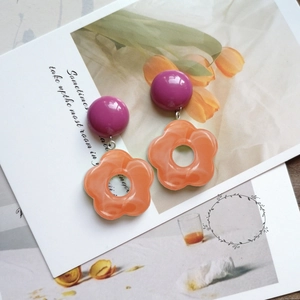 Artistic eco-friendly purple and orange acrylic five-petal flower drop earrings on card