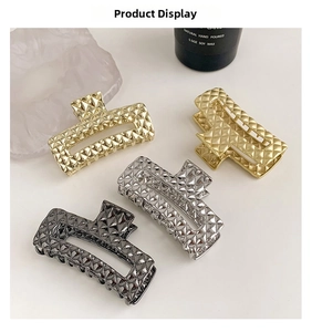 Detailed view of quilted texture metal hair claws in gold, silver and gunmetal black