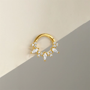 Close-up of golden S925 silver nose ring with kite-shaped white zircon stones detail