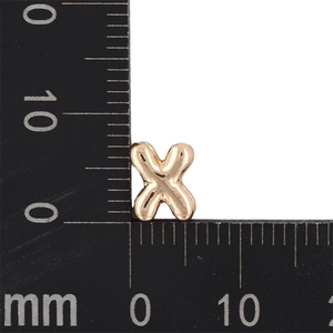 Macro shot of 8mm gold letter X bubble pendant measured with a metric ruler