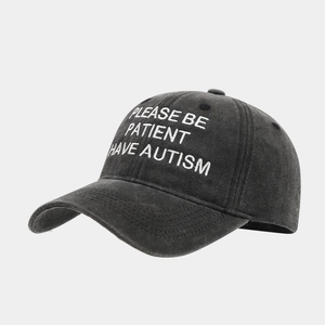 Washed dark gray cotton baseball cap with white PLEASE BE PATIENT I HAVE AUTISM embroidery