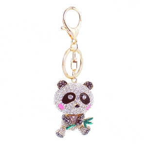 Cute panda keychain with sparkling crystals holding a green bamboo on a gold metal ring