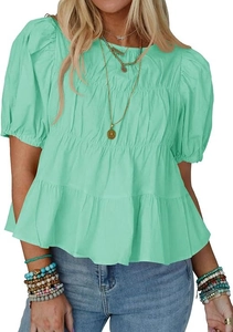 Detail of mint green tiered pleated blouse featuring puff sleeves and a round neckline