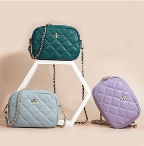 Detail of three quilted leather crossbody phone bags in green, blue, and purple shades