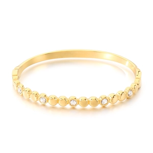 Bracelet jonc en acier titane doré avec disques circulaires et accents de zircone