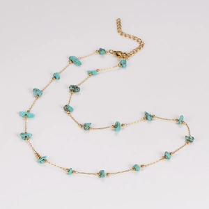 Detail of turquoise stones and adjustable golden chain on a vintage handmade necklace