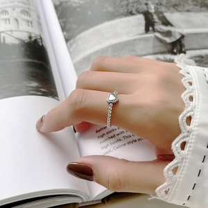 Detailed view of 925 sterling silver beaded ring with polished heart on a model