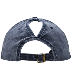 Detail of washed cotton baseball cap featuring back ponytail hole and adjustable metal buckle