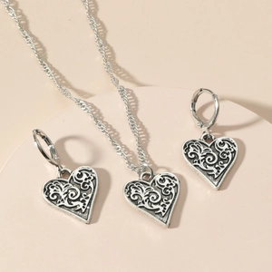Vintage silver hollow heart jewelry set with engraved swirl patterns on necklace and earrings