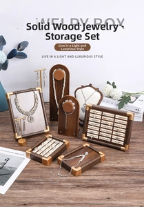 Detail of walnut wood jewelry display set with gold metal edges and velvet lining