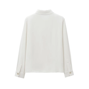 Back view of a white shoulder-padded crepe shirt with elegant gold button details