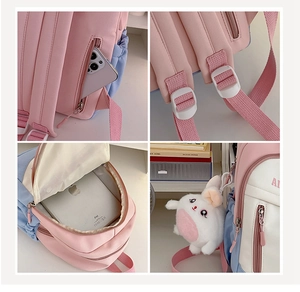 Detail view of pink and blue kids backpack showing back pocket and spacious main compartment