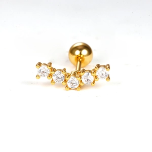 Detail of gold curved barbell ear stud with five sparkling zircons and screw ball back