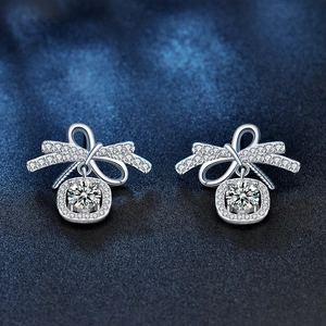 925 Sterling Silver Bow Moissanite Stud Earrings with halo pendant on blue texture