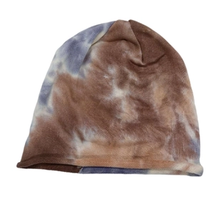 Detailed texture of tie-dye knit beanie in brown and misty blue with a rolled edge