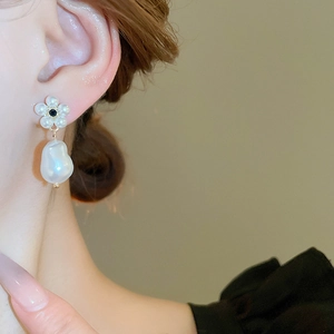 French vintage floral earrings with faux pearls and rhinestones on a female model