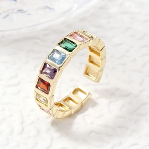 Macro view of adjustable gold clover ring with colorful rectangular zircon stones