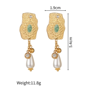 Detail view of gold earrings with green accents, white teardrop pearls and size labels
