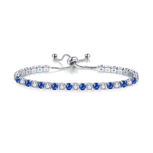 Detail of adjustable silver tennis bracelet featuring alternating blue and clear cubic zirconia