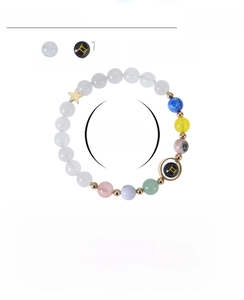 Detailed view of 8mm blue goldstone and white jade beads zodiac bracelet with Gemini symbol