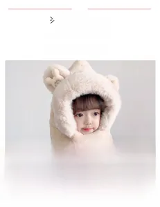 Detail of plush beige hooded scarf with bear ears and crown for kids' winter warmth