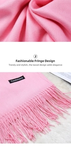 Detail of pink cashmere scarf featuring fine plain weave texture and long fringe edges