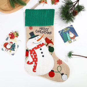 Linen Christmas stocking with snowman and Merry Christmas embroidery on festive background